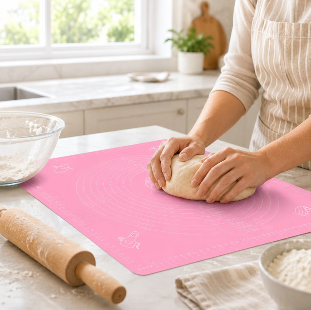 Dough being kneaded on a pink TIKA silicone pastry mat
