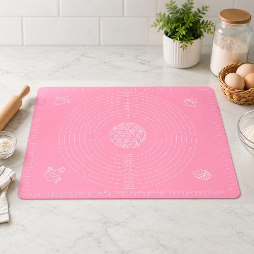 Pink TIKA silicone pastry mat with printed measuring guides on a kitchen counter