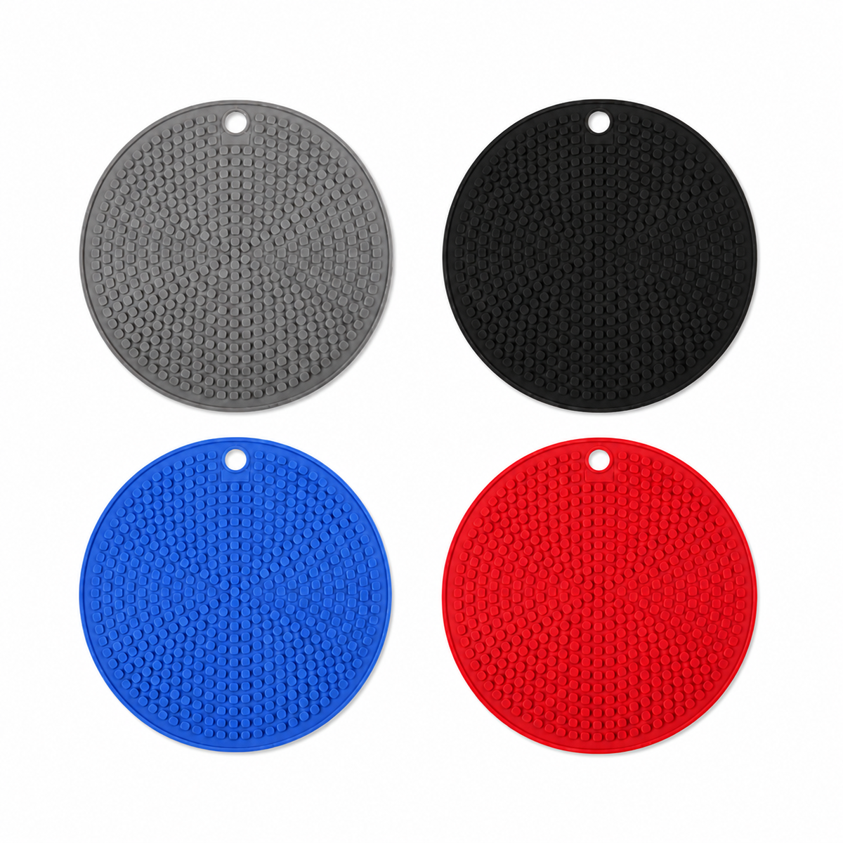 Four TIKA round silicone trivets in gray black blue and red